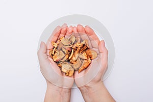 Female hands with sliced dried garden apples. Dried fruits. Healthy, natural foods. White background Close-up