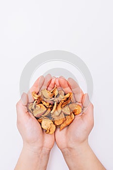 Female hands with sliced dried garden apples. Dried fruits. Healthy, natural foods. White background Close-up