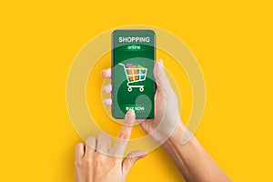 Female Hands With Smartphone Shopping Online Using Application, Yellow Background