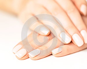 Female hands with smooth skin and stylish pink manicure.
