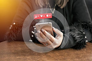 Young woman hands using smartphone with Instagram icons communication concept . photo