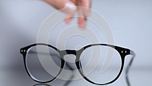 Female hands taking eyeglasses from table, vision correction, nearsightedness