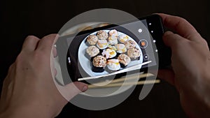 Female Hands Taking Photos of Prepared Food on a Smartphone on Table. Close up