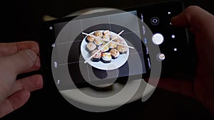 Female Hands Taking Photos of Prepared Food on a Smartphone on Table. Zoom