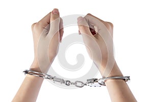 Female hands in tight fist on handcuff on white isolated background