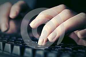 Female hands typing on computer keyboard