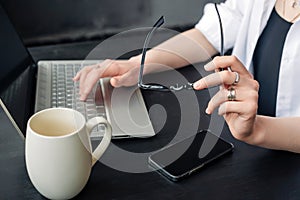 Female hands typing on computer keyboard closeup, business woman or student using laptop at home, online learning