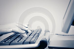 Female hands typing on computer keyboard