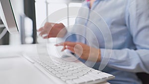 Female hands typing credit card number on computer keyboard. Woman making online purchase. Online payment service.