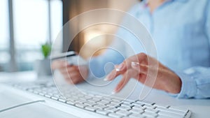 Female hands typing credit card number on computer keyboard. Woman making online purchase. Online payment service.