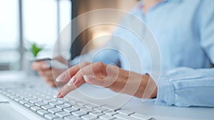 Female hands typing credit card number on computer keyboard. Woman making online purchase. Online payment service.