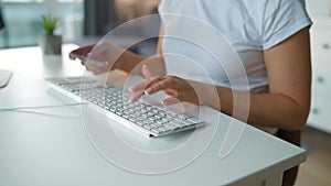 Female hands typing credit card number on computer keyboard. Woman making online purchase. Online payment service.