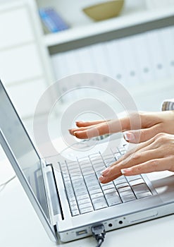 Female hands typing on keyboard