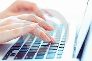 Female hands typing on the keyboard