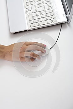 Female hands typing on keyboard, white computer