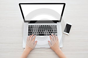 Female hands typing on a laptop keyboard