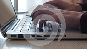 Female hands typing on a laptop keyboard