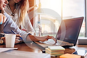 Female hands typing on laptop keyboard. Office work concept.