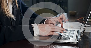 Female hands typing laptop keyboard and touching touchpad. Woman working with notebook. Hands close up view