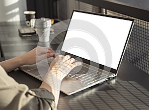 Female hands typing on laptop keyboard. Woman sitting in cafe and using computer mockup in work or study. City lifestyle