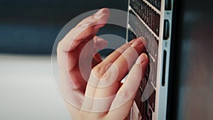 Female hands typing on laptop keyboard, writing messages,close up.Vertical video