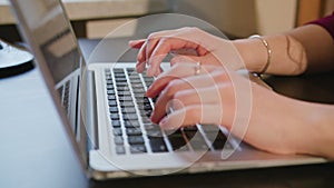 Female Hands Typing Text on Laptop Keyboard