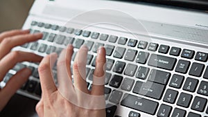 Female hands typing text on notebook keyboard. Teenager girl freelancer working on laptop. Woman reply e-mail, surfing net