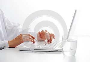 Female hands typing on a white computer