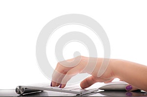 Female hands typing on white computer keyboard