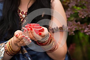 Female hands with unlit candles in form of roses