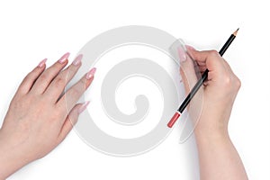 Female hands uses an eraser and black pencil on a white background. File contains a path to isolation