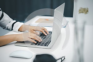 Female hands using laptop computer at home. Work from home concept