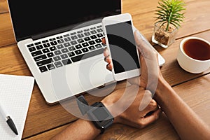 Female hands using modern digital gadgets at office workplace photo