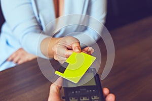 Female hands using payment terminal