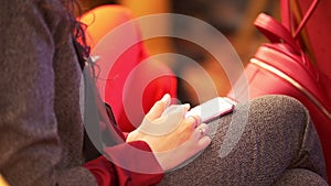 Female hands watching news feed on her phone sitting at a conference