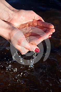 In the female hands water from the lake