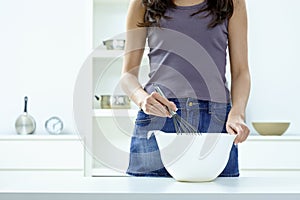 Female hands whipping eggs