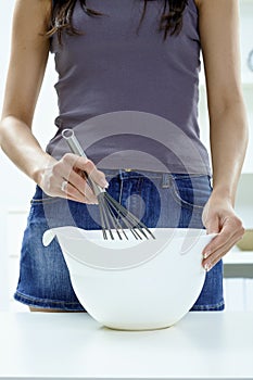 Female hands whipping eggs