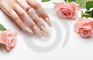 Female Hands on a white background with beautiful pearl manicure.Hands on a brown background and beautiful pearl manicure