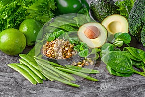 Female hands on a white background hold green spinach leaves. Healthy food concept. Fresh greens. Healthy diet