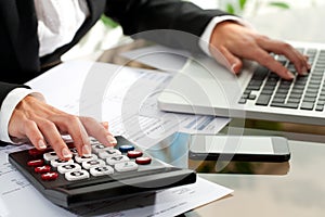 Female hands working on calculator.