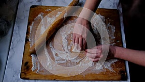 Female hands are working with the dough