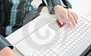 Female hands working on a laptop computer keyboard