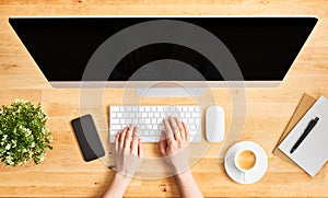 Female hands working on modern desktop computer