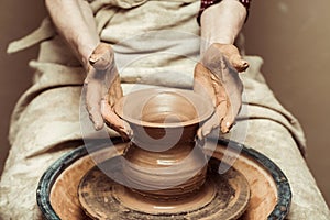 Female hands working on potters wheel