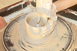 Female hands working on pottery wheel