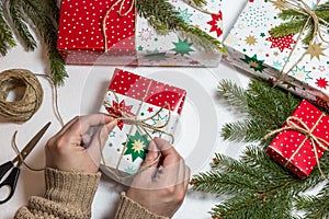 Female hands wrapping Christmas gift box