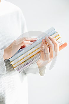 Female hangs gently holding pile of books