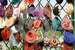 Many female headdresses are placed in a show-window.