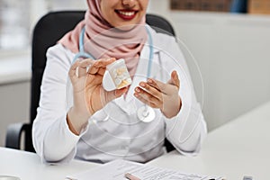 Female Health Practitioner Showing Pills